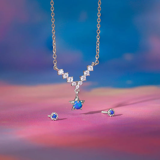 Blue opal necklace and earrings set with star motifs and zircon accents.