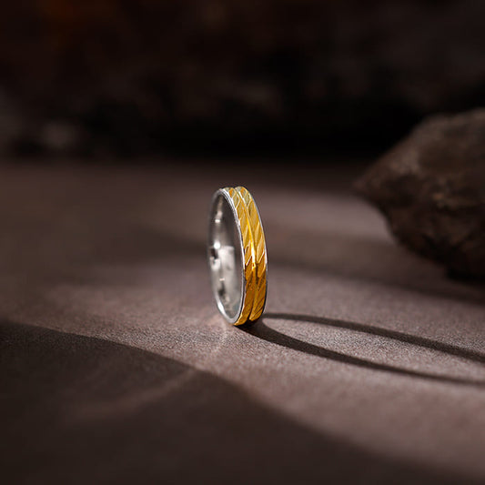 Men's dual-tone silver and gold band with intricate pattern, symbolising a unique journey.