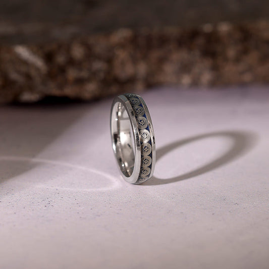 Men's silver band with intricate Om print, reflecting modern style and rugged charm.