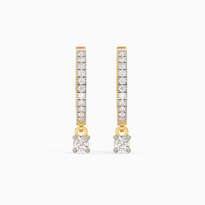 A pair of gold hoop diamond earrings with a dangling drop design