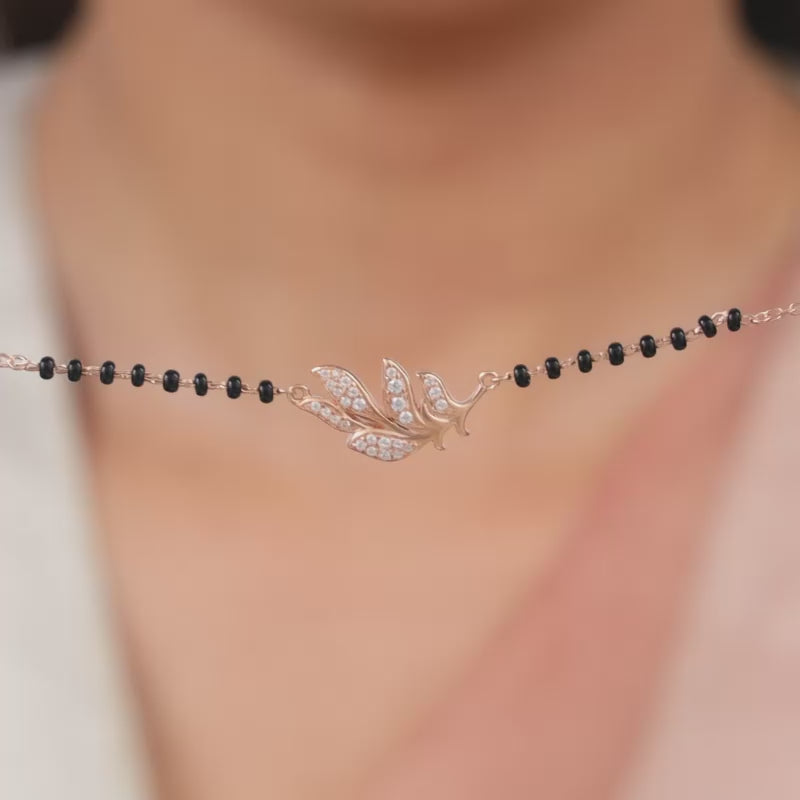 Rose Gold Feather Mangalsutra with zircons and black beads.