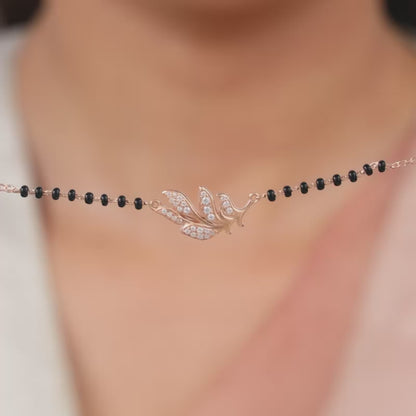 Rose Gold Feather Mangalsutra with zircons and black beads.